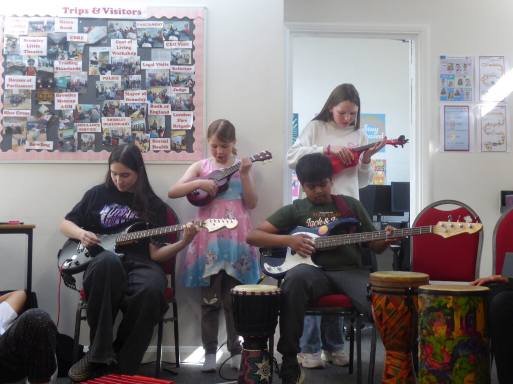 Young carers playing guitars and ukuleles as part of an inspired:arts music workshop.