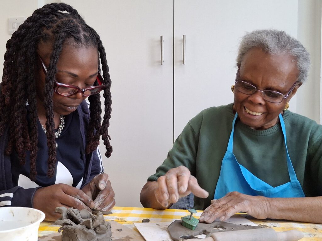 Older adults taking part in a Create ceramics workshop.