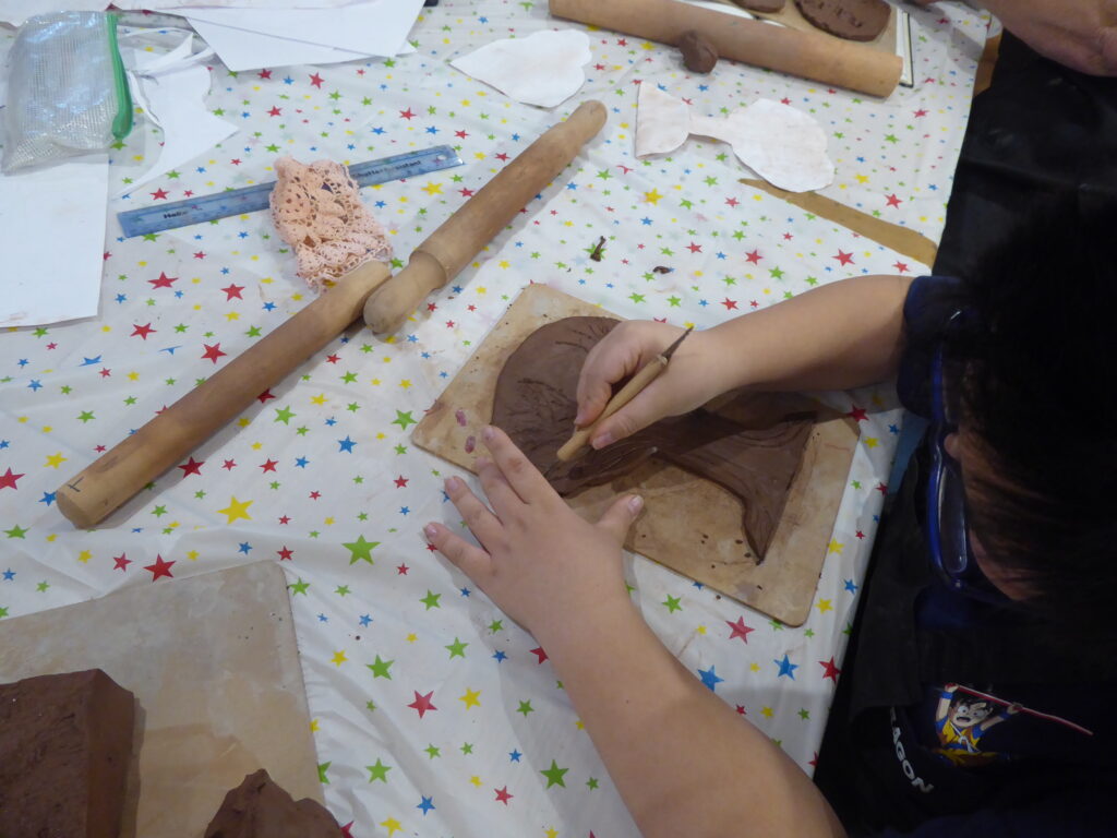Young carers taking part in a ceramics project.