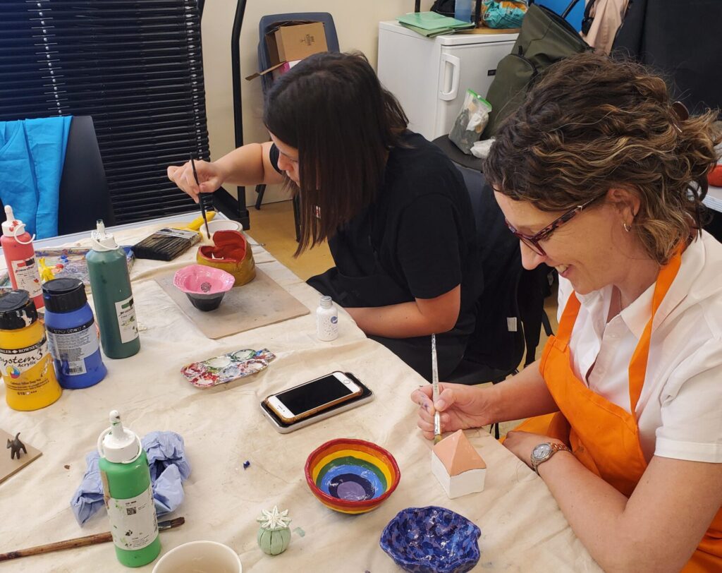 Older adults taking part in a ceramics workshop.