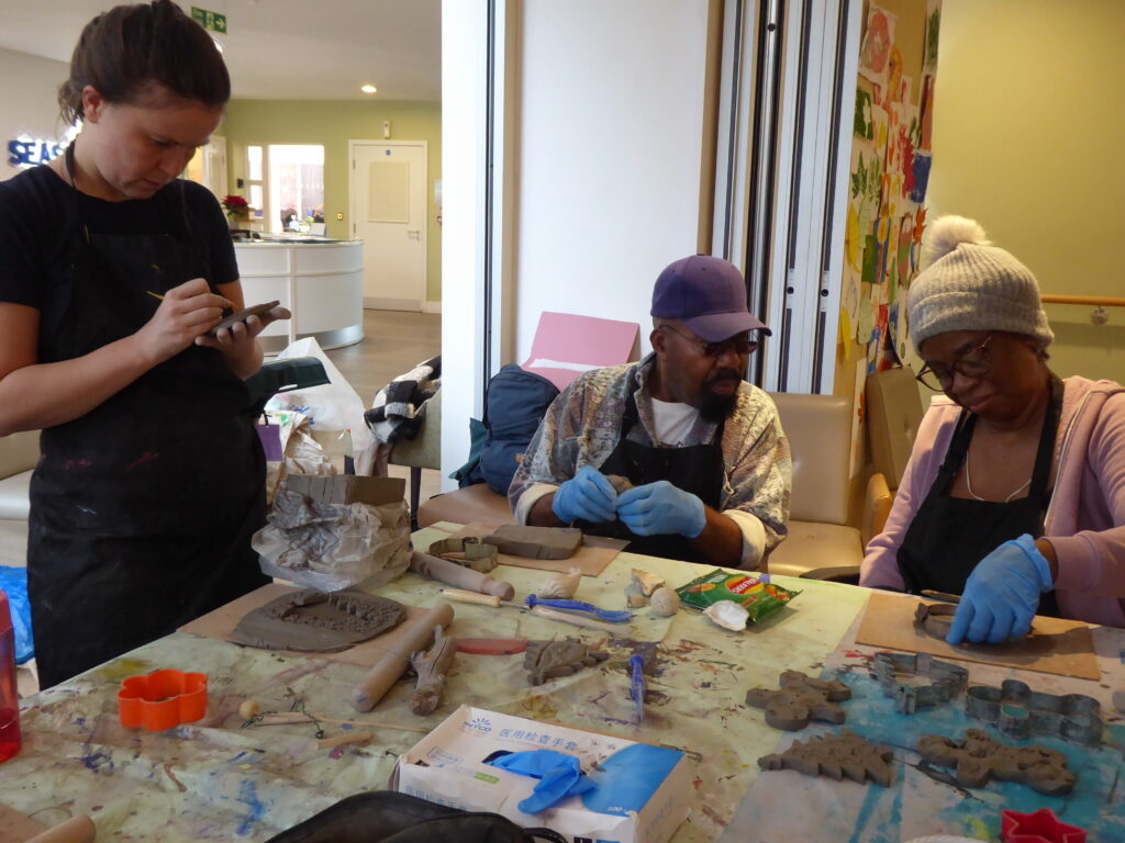 Older adults taking part in a ceramics workshop