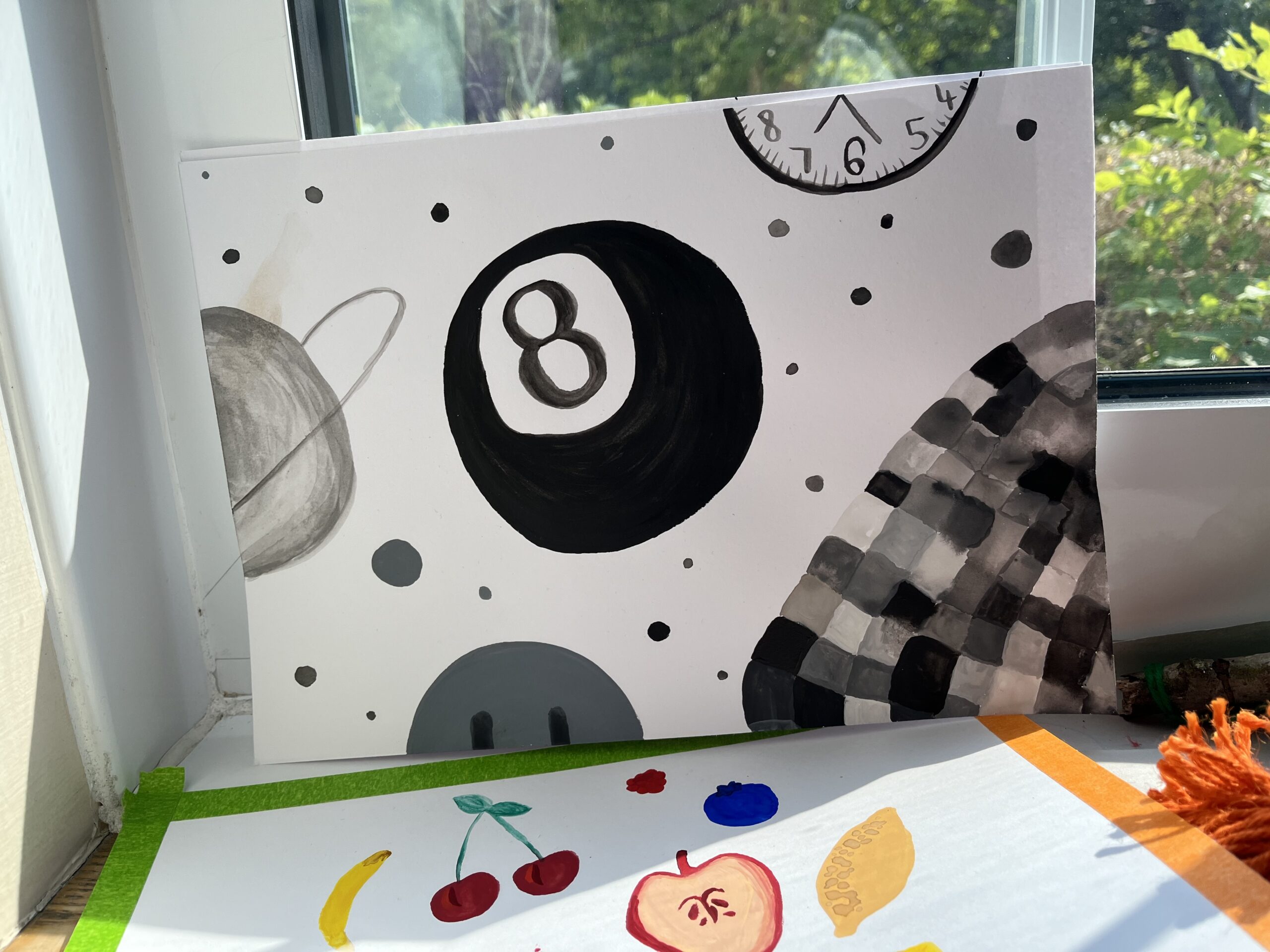 A black and white ink painting on a piece of paper that depicts an 8 snooker ball, and other graphics, taken at a creative:tandem project.